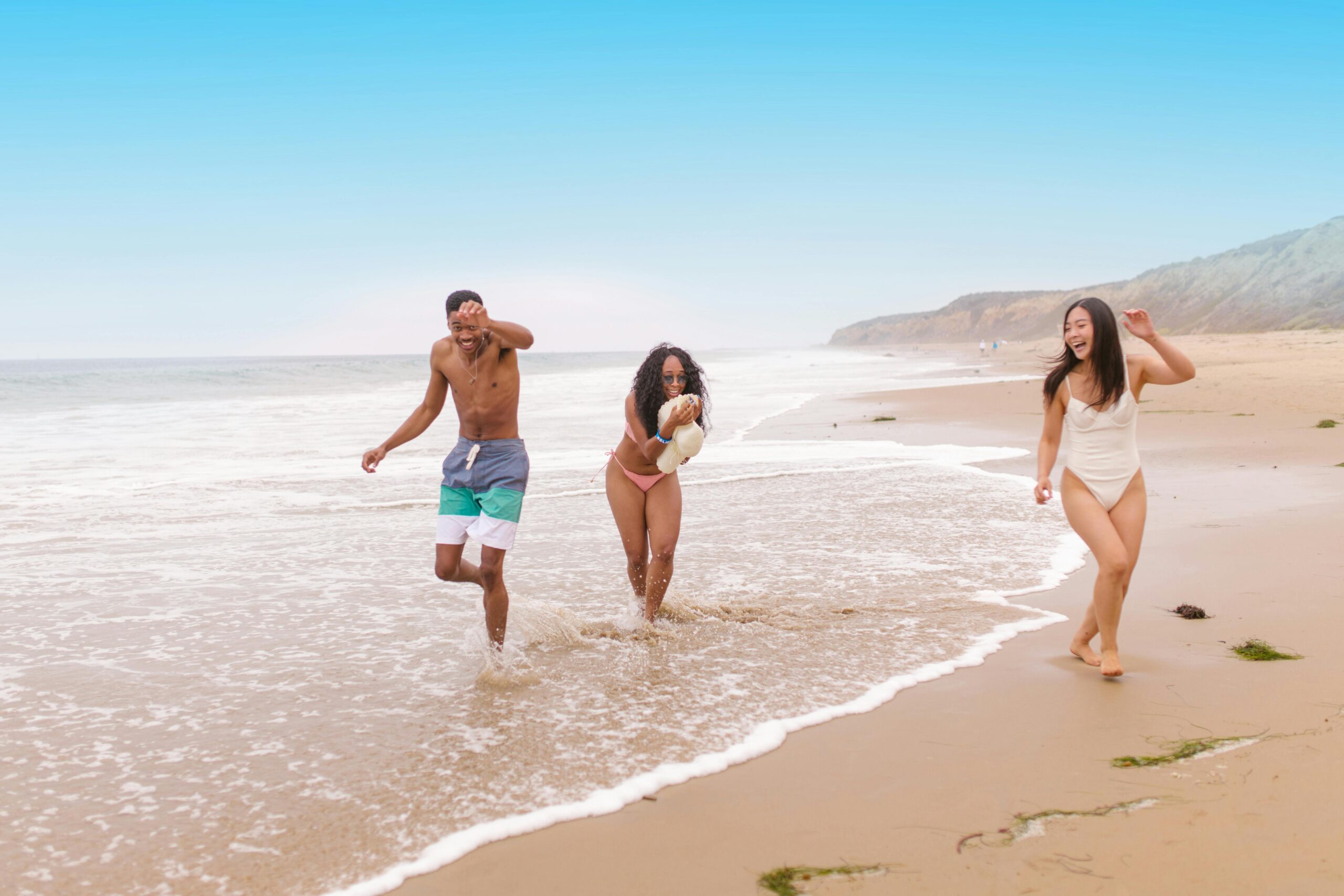 Diverse group of friends enjoying a lively day on a sunny beach.